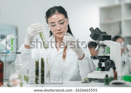 Scientists examining plant and algae samples in a modern laboratory, conducting pharmaceutical research to develop innovative medicine and explore natural treatments through advanced biotechnology
