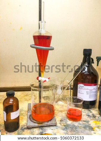 Scientists extracted Bromine Br2 and a chemical odor and corrosion in a fume hood in a chemistry laboratory of Southeast Asia.