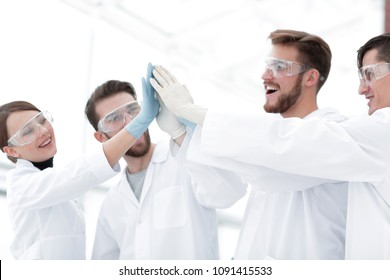 scientists giving each other a high five - Powered by Shutterstock