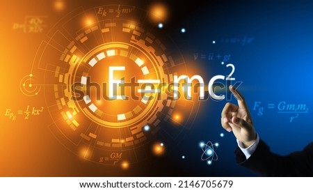 The scientist's hand points to the equation of relativity of Albert Einstein. E equals m multiplied by c squared. In the concept of a physics equation ring and a dark blue background.