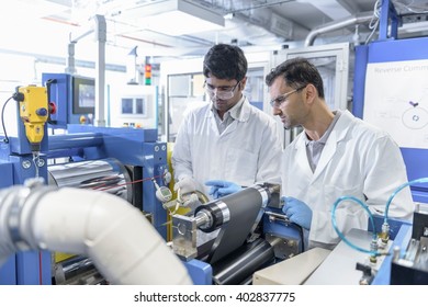 Scientists With Lithium Ion Battery Production Line In Battery Research Facility