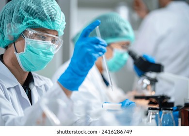 A Scientists or nutritionists are working on a sample of milk in biotechnology laboratory, genetic and bacteria research, dairy product quality control, protein, glucose and lactose percentage test. - Powered by Shutterstock