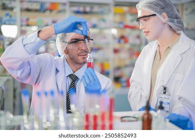 scientists perform experiments and record data. people arranges equipment with test tubes and chemicals for producing medicine and biochemistry. man hold tubes of chemical liquids and plant samples.