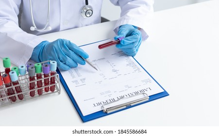 Scientists or physicians analyze the blood sample in vitro to prepare a vaccine against a new strain of viruses, Examination with blood test tubes, Vaccine Research and Science concept.