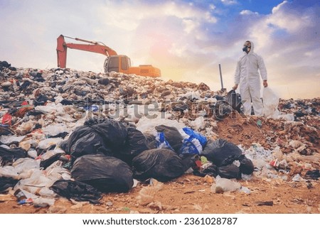 Scientists with protective suit, investigated and inspected garbage pile in landfill. An environment and conservation concept.