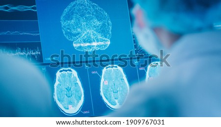 Scientists studying brainwave scanning models and DNA sequencesl.