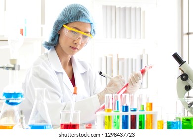Scientists are testing chemicals and taking notes of experiments.