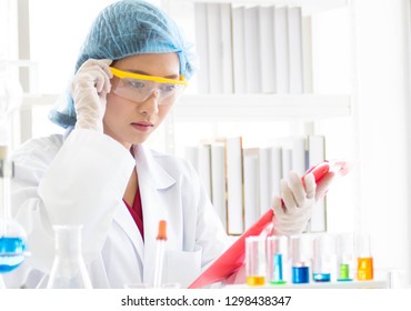 Scientists are testing chemicals and taking notes of experiments.