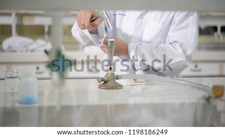Scientists use bunsen burner to burn substances in the test tube to remove water from chemicals in the chemical laboratory.