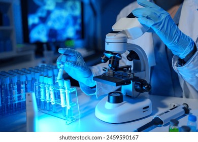 Scientists use scientific test tubes with records of chemicals or drugs being tested and examined under a microscope in a science laboratory for biology, biotechnology, medicine. - Powered by Shutterstock