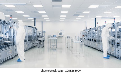 Scientists Working in Laboratory. Facility with Modern Industrial Machinery. Product Manufacturing Process: Pharmaceutics, Semiconductors, Biotechnology.
