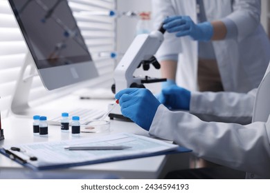 Scientists working with samples in laboratory, closeup. Medical research