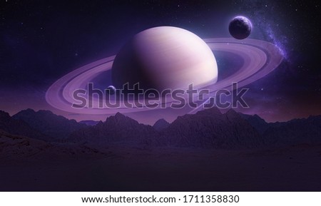 Sci-fi wallpaper of Saturn planet and mountains in the Earth. Night landscape. Elements of this image furnished by NASA Foto stock © 