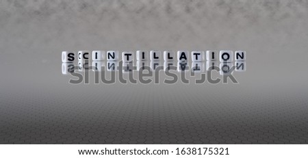 scintillation concept represented by wooden letter tiles