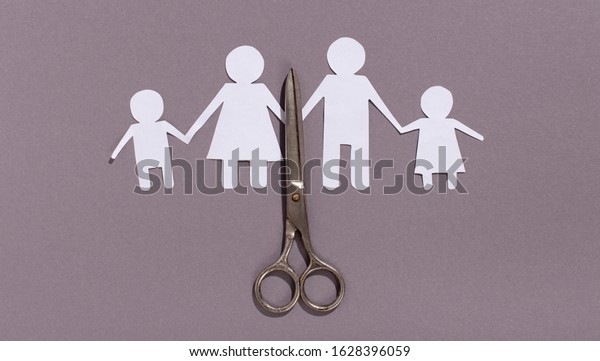 Scissor cutting family paper cut out on gray\
background, dysfunctional family, divorce parent, broken home\
concept, panorama