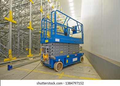 Scissor Lift Aerial Work Platform In Distribution Warehouse