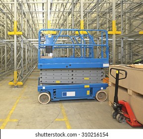 Scissor Lift Aerial Work Platform In Distribution Warehouse