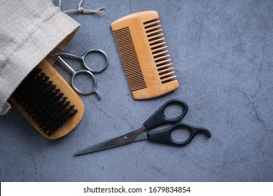 Scissors, Brush And Comb On Concrete Background. Beard Take Care Kit. Top View. Flat Lay.