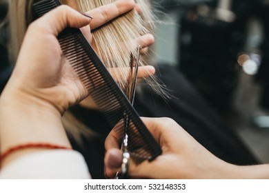 Scissors cut the girls hair - Powered by Shutterstock