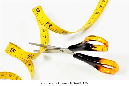 Scissors Cut The Measuring Tape. Control The Waist Size When Planning A Diet. The Concept Is To Fight Obesity, Improve Health And Increase Aesthetic Appeal.