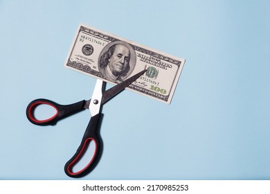 Scissors Cut Money Dollars On Black Background. Financial Concept