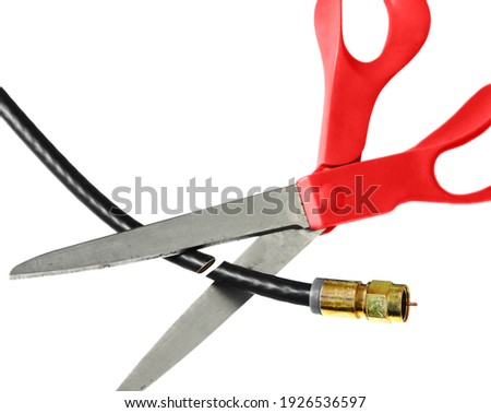 Scissors cut through a coaxial cable on white - cutting the cord tv concept                               