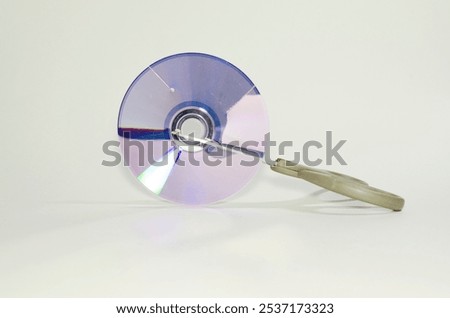 Scissors cutting a cd rom