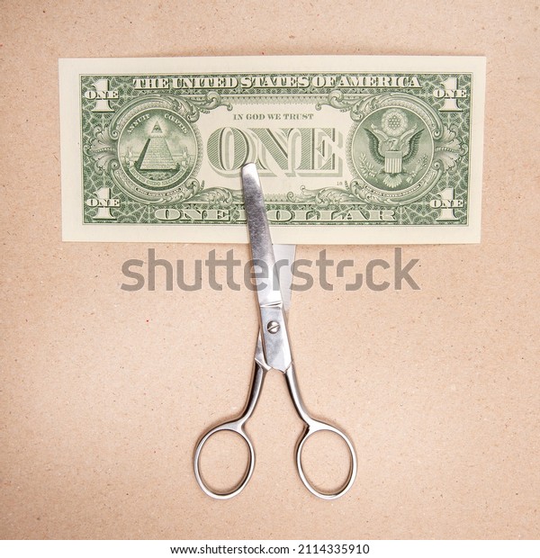 scissors for\
cutting dollar on paper\
background