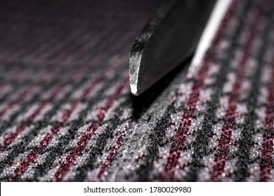 Scissors cutting fabric. Macro photography