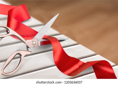 Scissors Cutting Red Ribbon