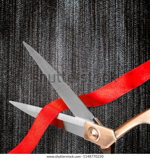 Scissors cutting red\
ribbon