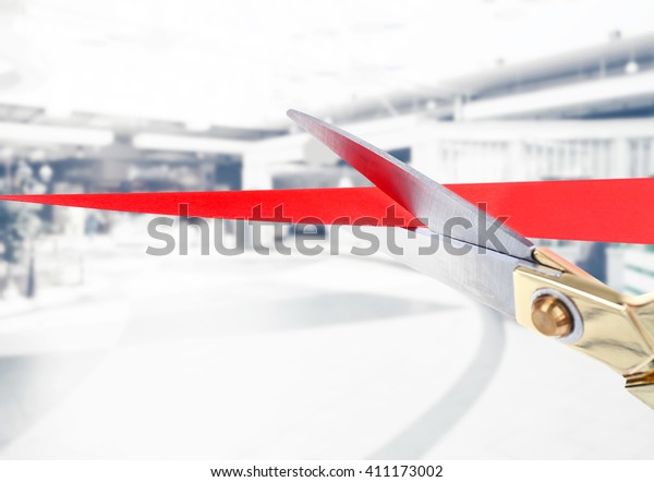 Scissors cutting red ribbon\
close up