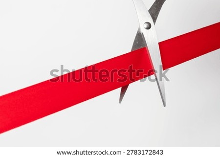 scissors cutting a red ribbon on clean background, symbolizing business launch, grand opening, success, achievement, and new beginnings in corporate or startup concept.