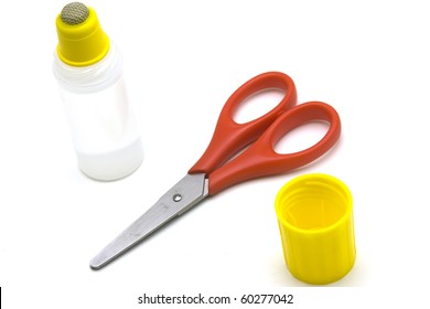 Scissors And Glue Over White Background