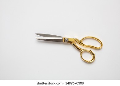 Scissors gold and silver color isolated against white background, copy space, top view. Tailor, barber concept