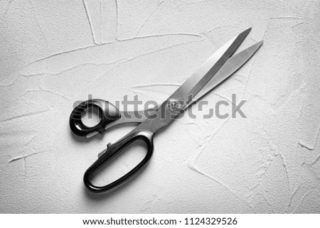 Scissors on light background, top view. Tailoring equipment