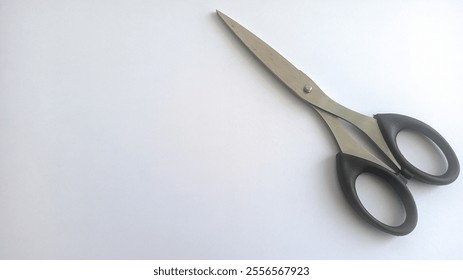 the scissors placed on a white surface.