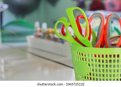 Scissors in a plastic basket with soft focus