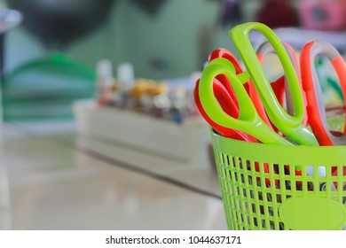 Scissors in a plastic basket with soft focus