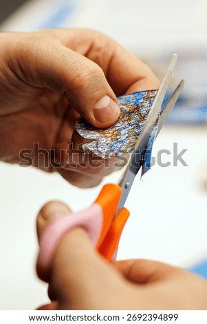 Scissors precisely cutting a heart from a map. Symbolic for travel, handmade gifts, or personal memory keepsakes.