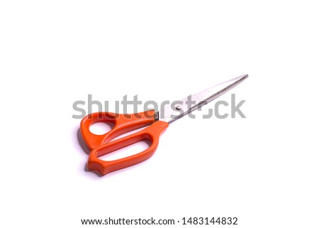 
Scissors with a red handle placed on a white background