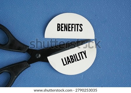 Scissors and two separate pieces of paper with the different words Benefits and Liability. business risk management or insurance coverage. It balances the advantages or compensation provided with the legal and financial obligations or risks attached to them.