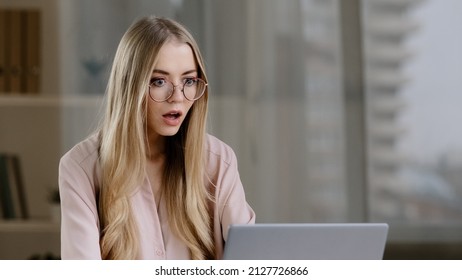 Scocked Caucasian Millennial Business Woman Female Student Worker User Receiving Bad News Message Low Grade Test Failed Exams Losing Computer Bet Feeling Shock Lost Fear Horror Looking At Laptop