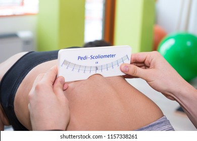 Scoliosis Screening With Pedi-Scoliometer On Young Person Spine
