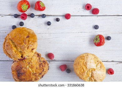 Scones Raspberries Strawberries And Blueberries Shot From Above On Wooden Boards Landscape