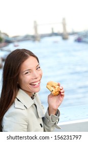 Scones - Woman Eating Scone In London. Happy Girl Holding British Pastry By River Thames, London, England, United Kingdom