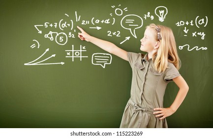 Scoolgirl standing in class near a green blackboard - Powered by Shutterstock