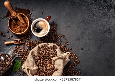 Scoop of coffee beans in a bag on dark background. Top view of coffee in a cup. Copy space for text - Powered by Shutterstock