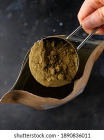 Scoop Of Hemp Vegan Protein Powder On Dark Rustic Background