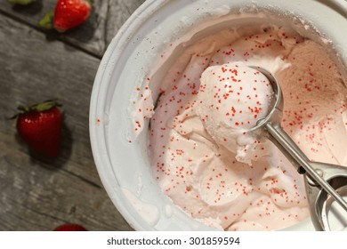 Scoop Of Homemade Strawberry Ice Cream  In Ice Cream Maker, Overhead View